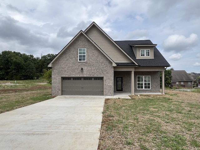 view of front of house featuring a front lawn and a garage