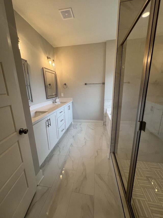 bathroom featuring vanity and shower with separate bathtub