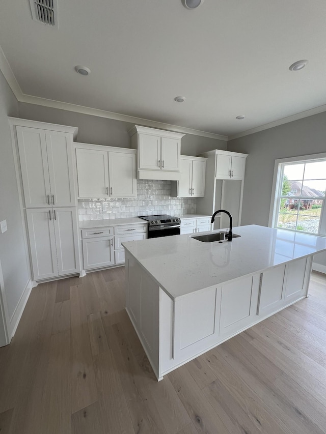 kitchen with white cabinetry, sink, stainless steel electric range oven, light hardwood / wood-style flooring, and crown molding