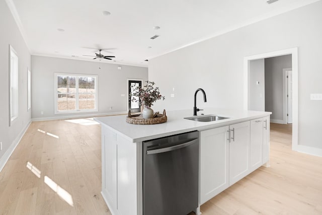 kitchen with white cabinetry, sink, a kitchen island with sink, stainless steel dishwasher, and light hardwood / wood-style flooring