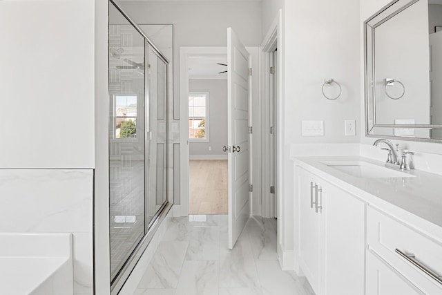 bathroom featuring vanity and a shower with door