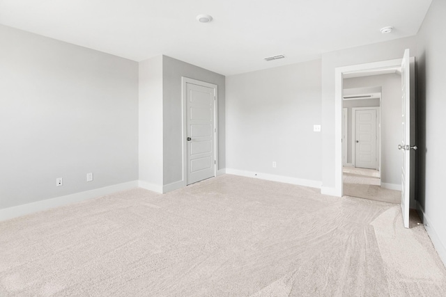 empty room with light colored carpet