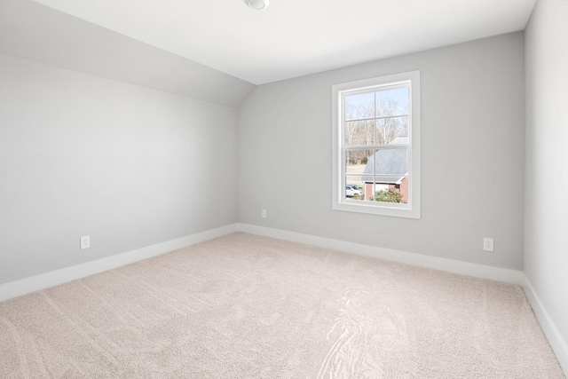 bonus room with lofted ceiling and carpet flooring