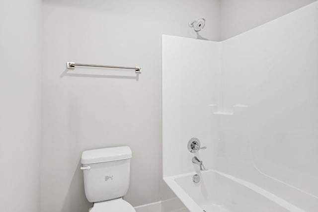 bathroom with tub / shower combination and toilet