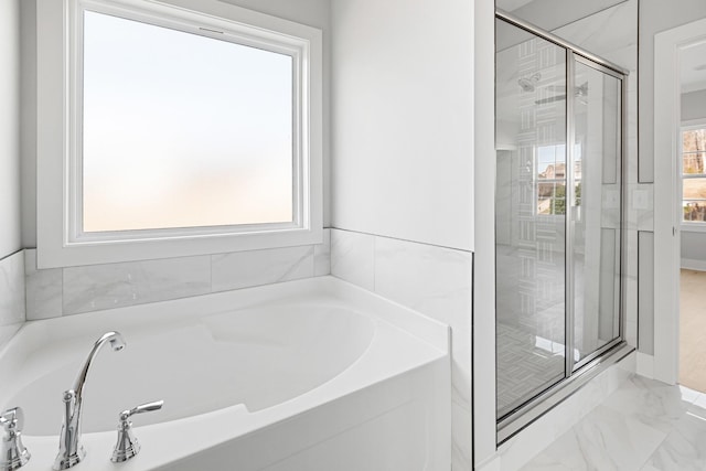 bathroom featuring shower with separate bathtub