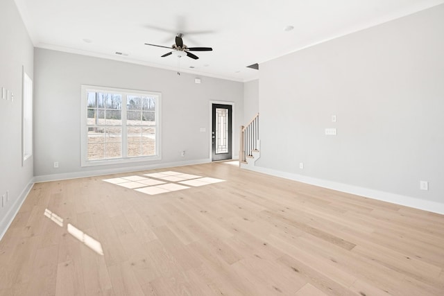 empty room with ornamental molding, ceiling fan, and light hardwood / wood-style flooring