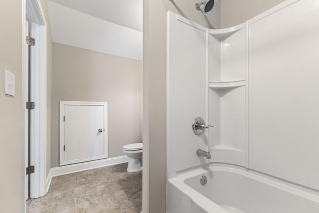 bathroom with toilet and bathtub / shower combination