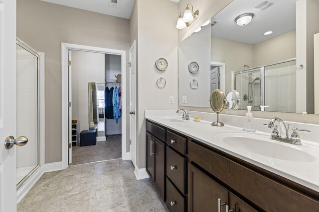 bathroom featuring vanity and an enclosed shower