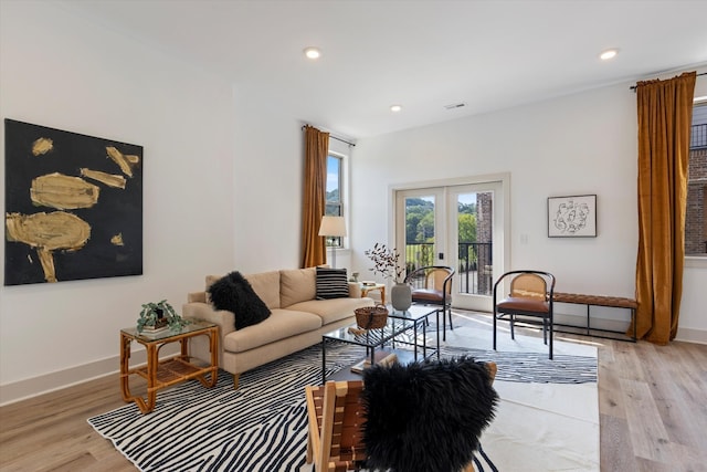 living room featuring french doors and light hardwood / wood-style floors