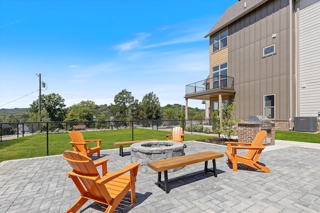 view of patio featuring an outdoor fire pit, exterior kitchen, a balcony, central AC unit, and grilling area