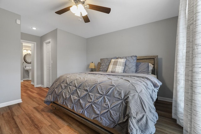 bedroom with ceiling fan, hardwood / wood-style floors, and connected bathroom