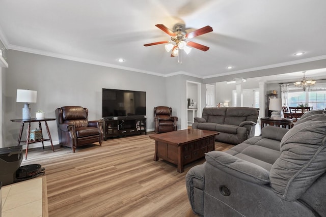 living room with light wood-type flooring, ornate columns, crown molding, and ceiling fan with notable chandelier