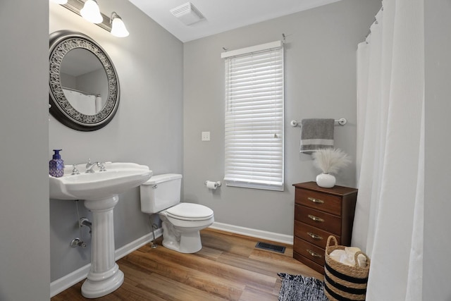 bathroom featuring toilet and hardwood / wood-style flooring