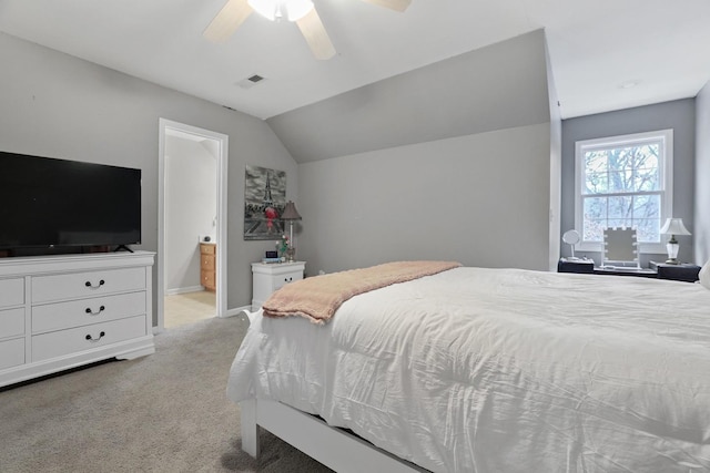 carpeted bedroom featuring ceiling fan, connected bathroom, and vaulted ceiling