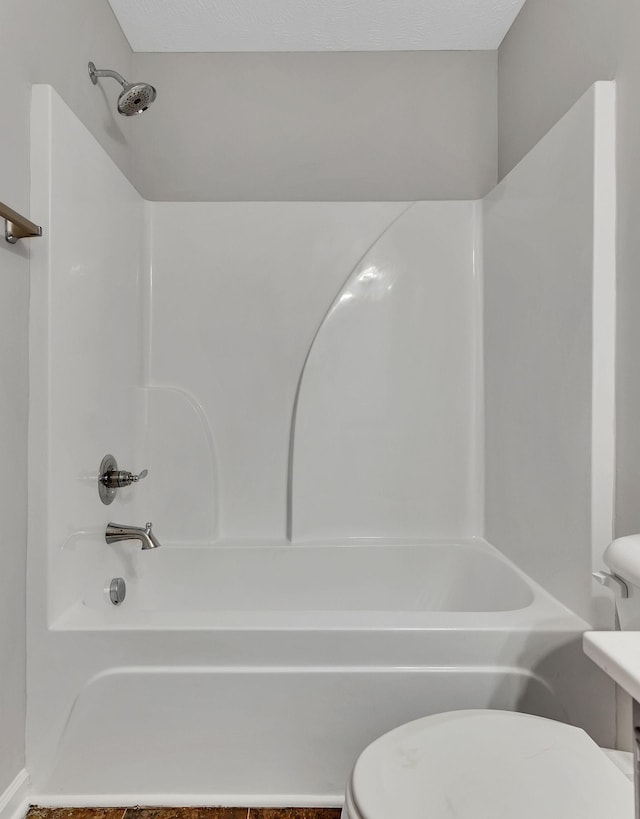 bathroom featuring toilet and bathing tub / shower combination