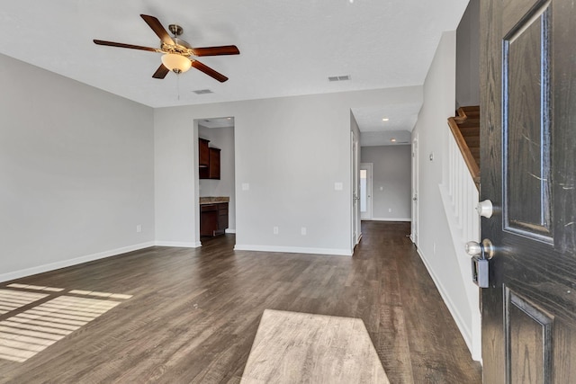 interior space with ceiling fan and dark wood-type flooring