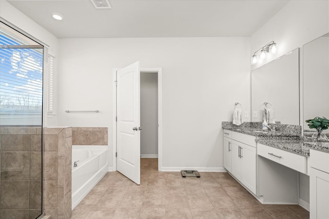 bathroom featuring a tub to relax in and vanity