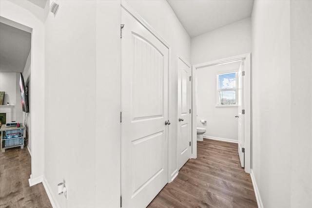 corridor with hardwood / wood-style floors