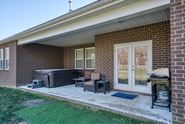 view of patio with french doors, a hot tub, and area for grilling