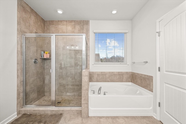 bathroom with tile patterned flooring and separate shower and tub