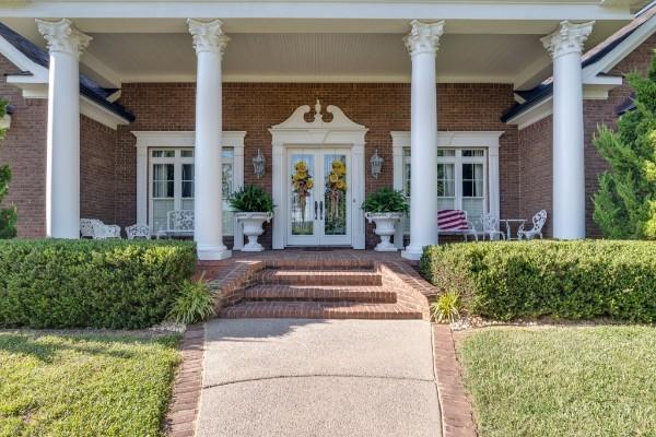 entrance to property with french doors and a porch