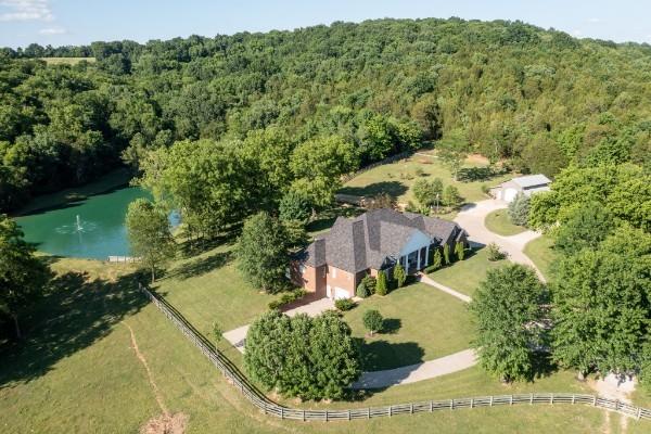 drone / aerial view with a water view and a rural view