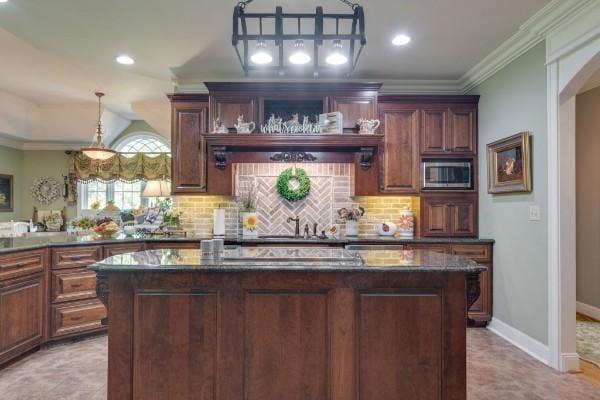 bar featuring stainless steel microwave, dark stone counters, tasteful backsplash, and ornamental molding