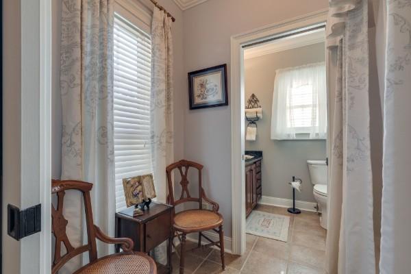 interior space with plenty of natural light, light tile patterned floors, and ornamental molding