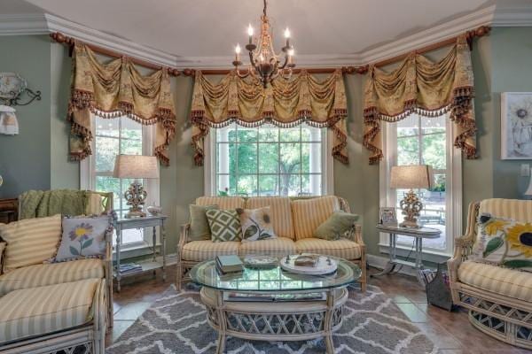 living area with a wealth of natural light, tile patterned flooring, ornamental molding, and a chandelier