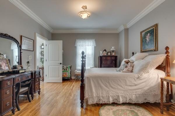 bedroom featuring light wood-type flooring and crown molding