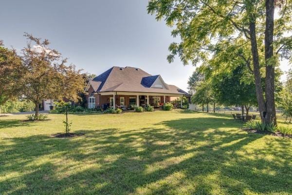 view of yard featuring covered porch