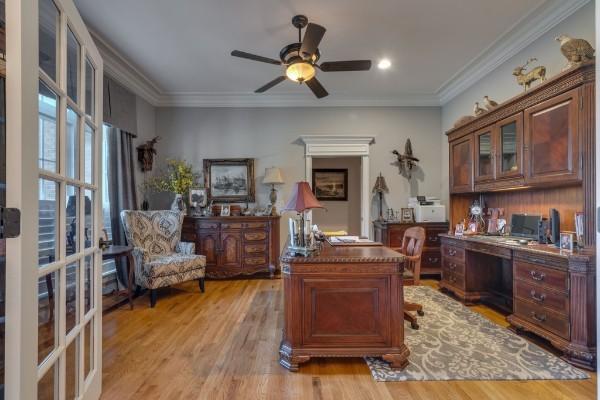 office with ceiling fan, ornamental molding, and light hardwood / wood-style flooring