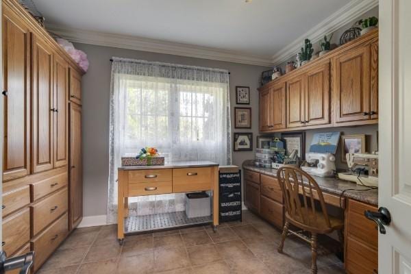 office area with ornamental molding and built in desk