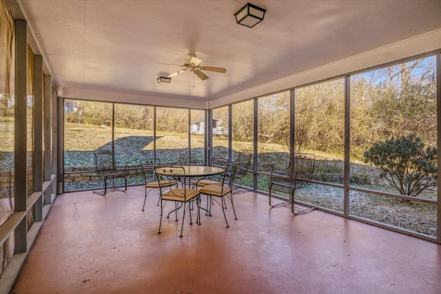 unfurnished sunroom with ceiling fan and plenty of natural light