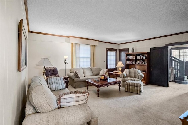 living room with light colored carpet, crown molding, and a textured ceiling