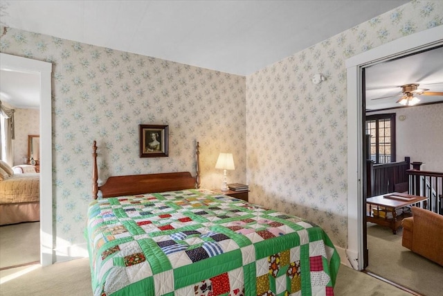 carpeted bedroom with ceiling fan and a closet