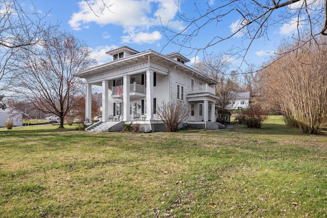 rear view of property featuring a lawn, a balcony, and a porch