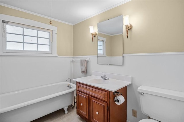 bathroom featuring toilet, vanity, tile patterned floors, a tub to relax in, and ornamental molding