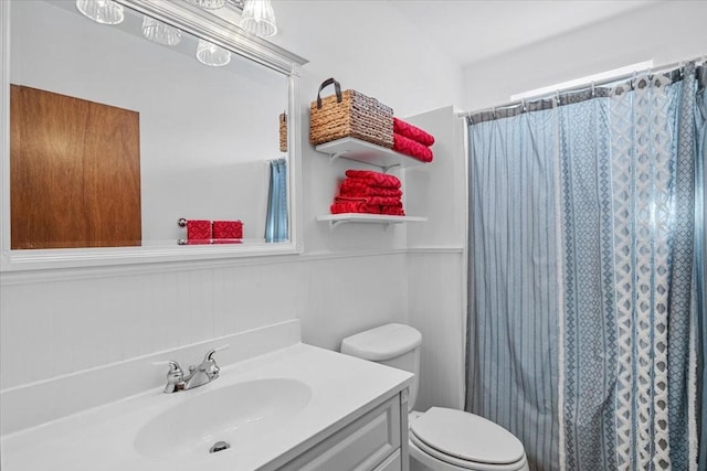 bathroom featuring toilet, a shower with curtain, and vanity