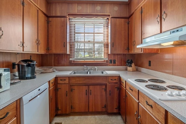 kitchen with sink, white appliances, and light tile patterned flooring