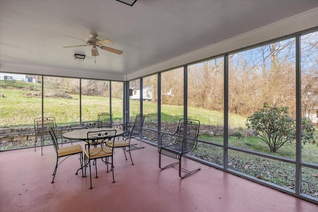 unfurnished sunroom with ceiling fan