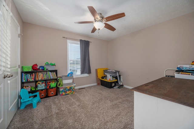 recreation room featuring carpet and ceiling fan