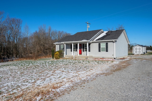 ranch-style house featuring a shed and a porch