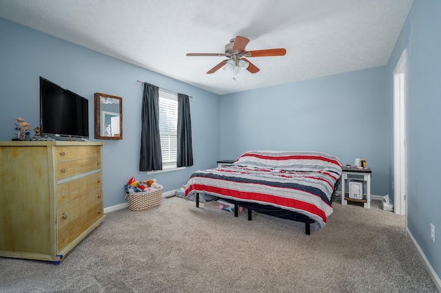 carpeted bedroom featuring a textured ceiling and ceiling fan