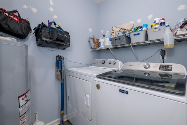 clothes washing area with washing machine and clothes dryer and water heater