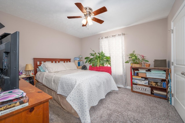 bedroom featuring carpet flooring, a textured ceiling, and ceiling fan