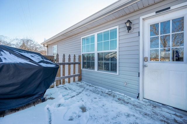 view of snow covered property entrance