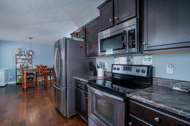 kitchen featuring decorative light fixtures, dark hardwood / wood-style flooring, stainless steel appliances, dark brown cabinets, and a textured ceiling