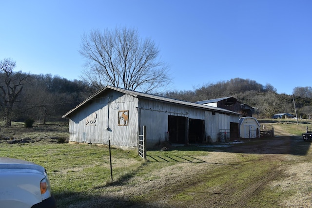 view of outbuilding featuring a yard