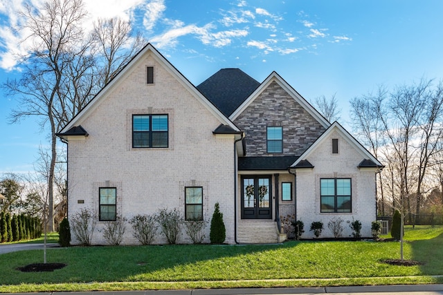 view of front of home featuring a front lawn and french doors